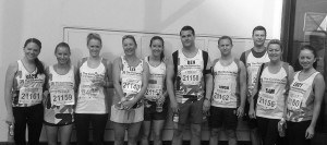 a group of people standing wearing branded t-shirts